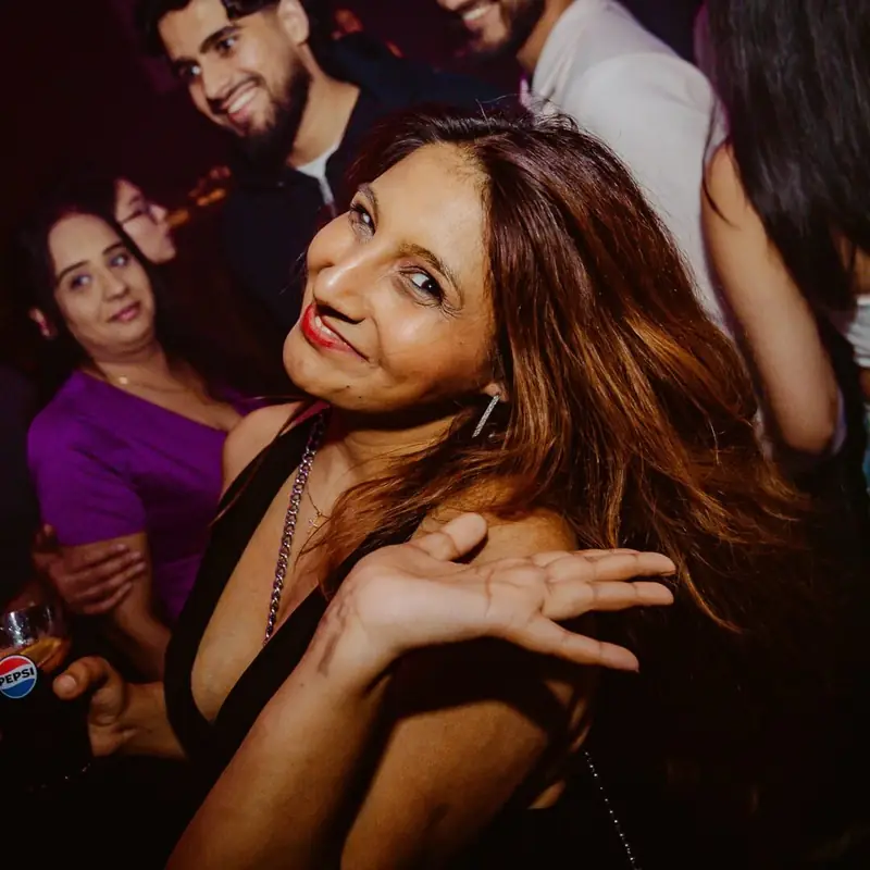 Guest smiling in the crowd at HEY DESI